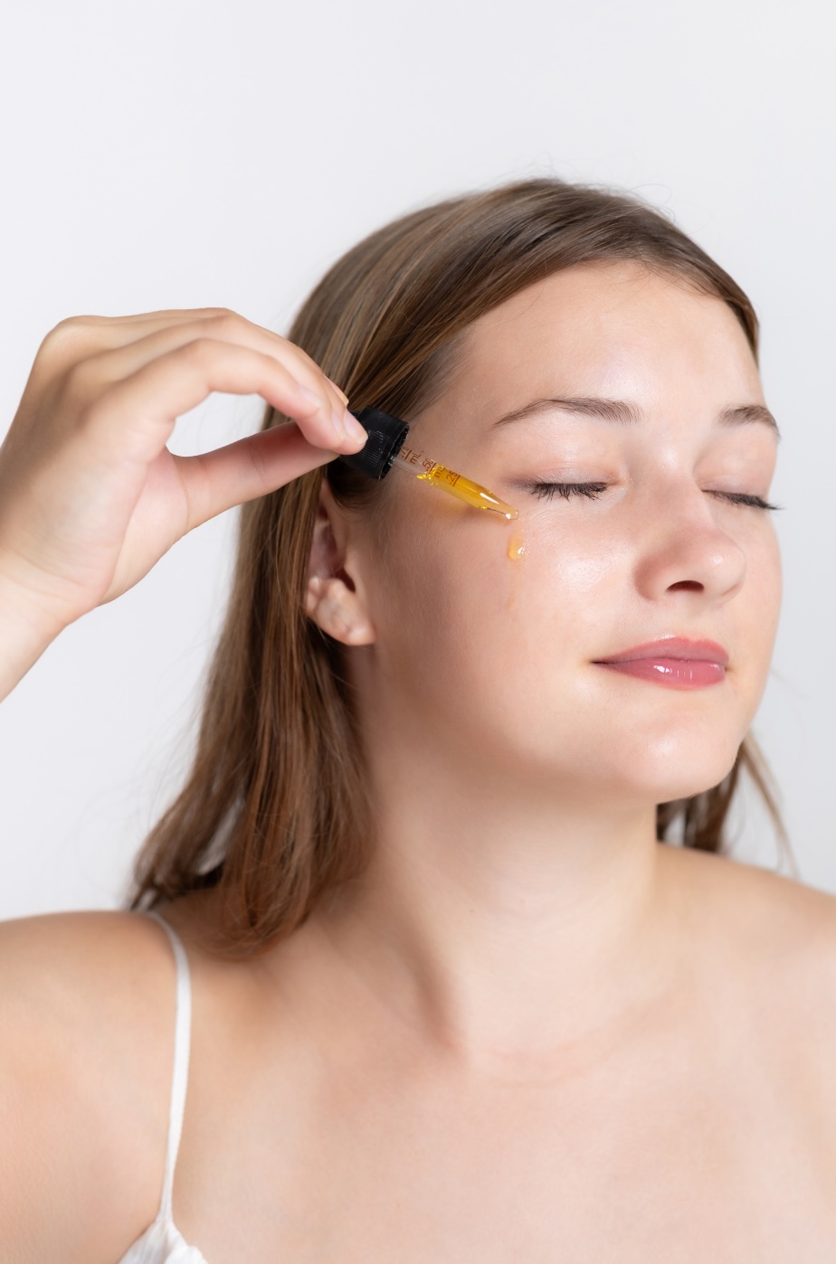 Woman applying facial oil
